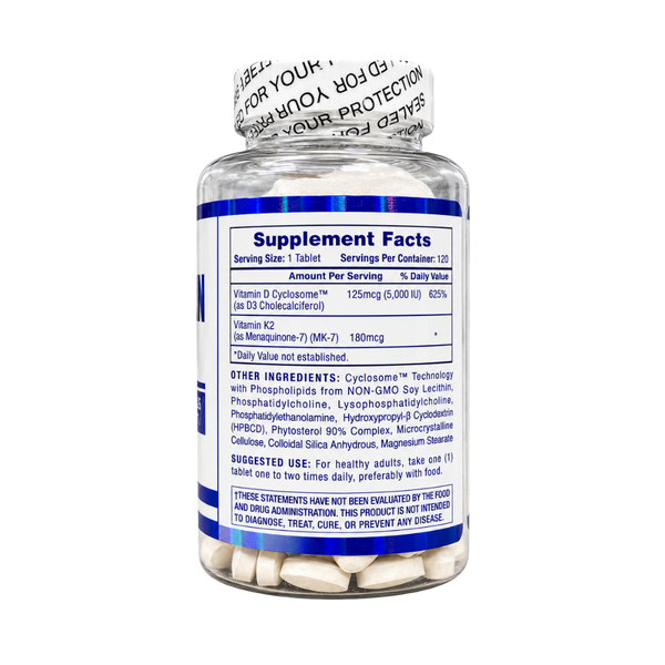 A clear supplement bottle with a white cap and a blue label showing Supplement Facts, filled with white tablets. The label includes text for Vitamin D chloride, Vitamin K2, and lists ingredients and usage information.