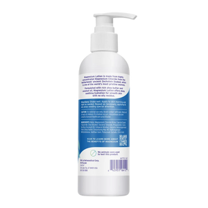 A white pump bottle of Magnesium Lotion shown from the back, featuring a detailed blue and white product information label, barcode, and QR code on a plain white background.