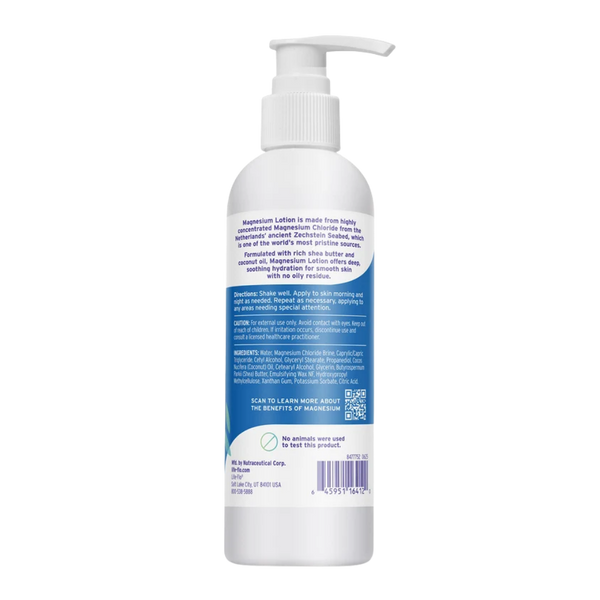 A white pump bottle of Magnesium Lotion shown from the back, featuring a detailed blue and white product information label, barcode, and QR code on a plain white background.