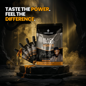 A stand-up pouch of VigorLabs Black Snake Honey is displayed on a dark stone pedestal with several honey drops dripping beside it. The background is smoky and dark with dramatic lighting, and large marketing text at the top reads 'TASTE THE POWER.